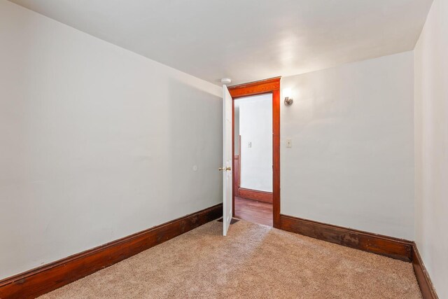 604 Edgewood St, Jackson, MI 49202 - empty room featuring light colored carpet, baseboards, and a smoke detector