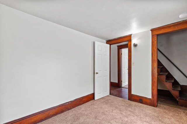 604 Edgewood St, Jackson, MI 49202 - carpeted spare room featuring baseboards and stairway