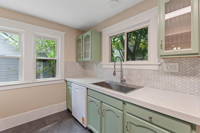 604 Edgewood St, Jackson, MI 49202 - kitchen featuring green cabinets, a sink, dishwasher, tasteful backsplash, and light countertops