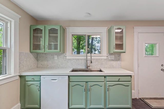 604 Edgewood St, Jackson, MI 49202 - kitchen with green cabinets, white dishwasher, a sink, and healthy amount of natural light