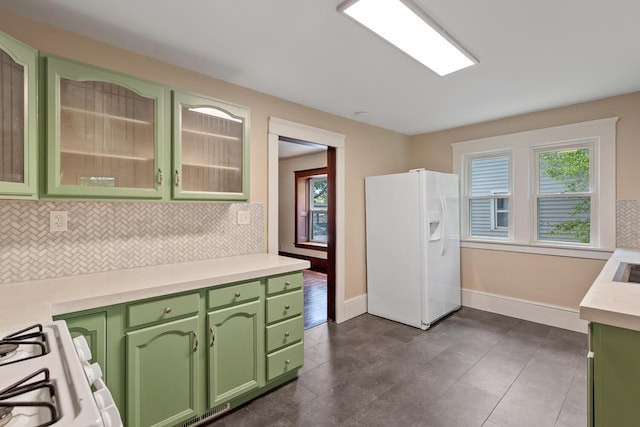 604 Edgewood St, Jackson, MI 49202 - kitchen with white appliances, green cabinetry, and backsplash