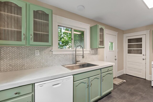 604 Edgewood St, Jackson, MI 49202 - kitchen featuring green cabinetry, dishwasher, a sink, and backsplash