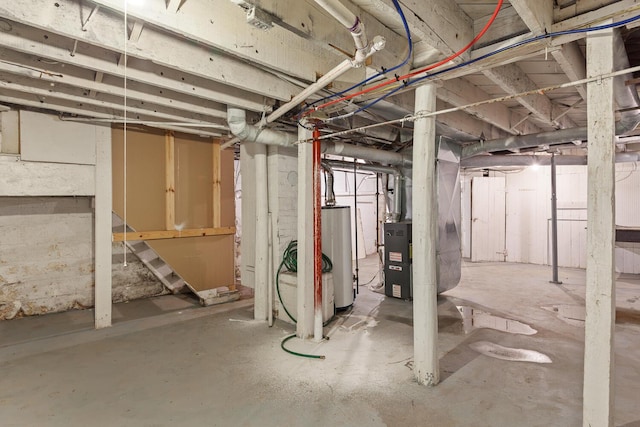 604 Edgewood St, Jackson, MI 49202 - unfinished basement featuring gas water heater and heating unit