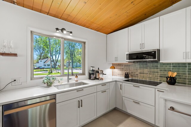 520 N W St, Coloma, MI 49038 - kitchen with appliances with stainless steel finishes, a sink, wooden ceiling, decorative backsplash, and white cabinetry
