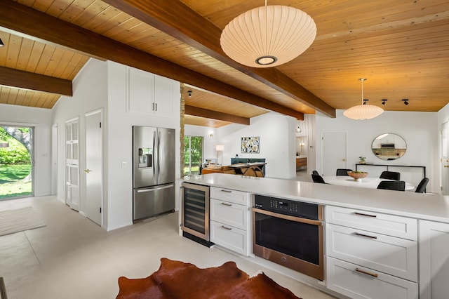 520 N W St, Coloma, MI 49038 - kitchen with stainless steel appliances, wine cooler, wooden ceiling, white cabinets, and open floor plan