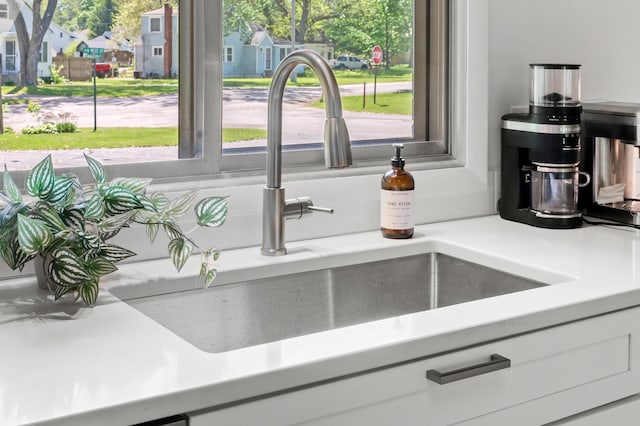 520 N W St, Coloma, MI 49038 - kitchen featuring a sink, light countertops, plenty of natural light, and white cabinets