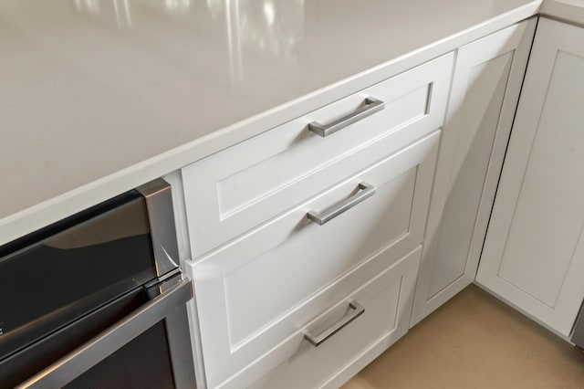520 N W St, Coloma, MI 49038 - kitchen view of light countertops, light colored carpet, white cabinetry, and wine cooler