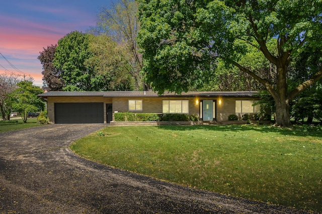 520 N W St, Coloma, MI 49038 - view of front facade with an attached garage, driveway, and a front yard