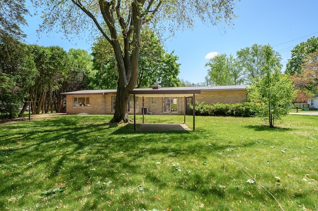 520 N W St, Coloma, MI 49038 - view of front of home featuring a front lawn, metal roof, and a chimney