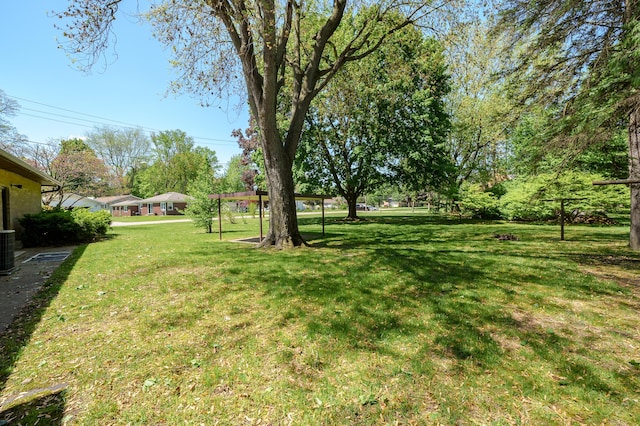 520 N W St, Coloma, MI 49038 - view of grassy yard featuring central air condition unit