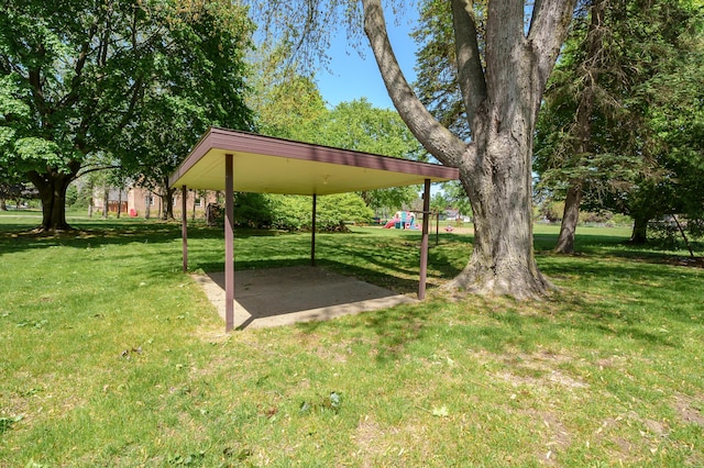 520 N W St, Coloma, MI 49038 - view of grassy yard featuring a playground and a carport