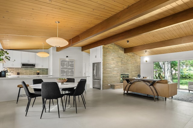 520 N W St, Coloma, MI 49038 - dining area with wood ceiling, concrete flooring, and a fireplace