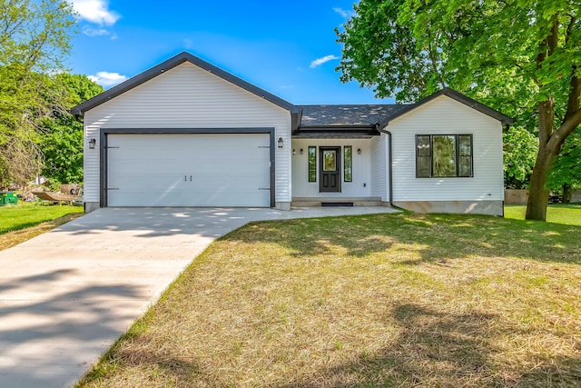 611 River Rd, Marshall, MI 49068 - view of front of home featuring an attached garage, driveway, and a front lawn