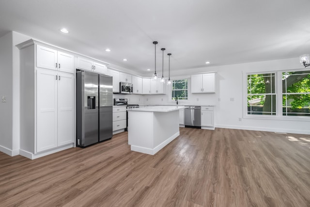 611 River Rd, Marshall, MI 49068 - kitchen with appliances with stainless steel finishes, light wood-style flooring, white cabinets, light countertops, and recessed lighting