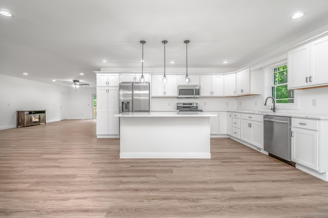 611 River Rd, Marshall, MI 49068 - kitchen featuring stainless steel appliances, recessed lighting, open floor plan, light countertops, and white cabinets