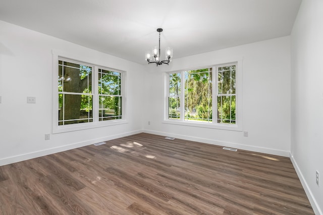 611 River Rd, Marshall, MI 49068 - unfurnished room featuring healthy amount of natural light, baseboards, a chandelier, and dark wood-style floors