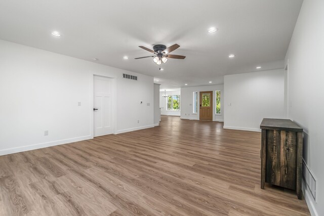 611 River Rd, Marshall, MI 49068 - unfurnished living room featuring a ceiling fan, recessed lighting, light wood finished floors, and baseboards