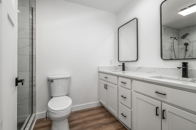 611 River Rd, Marshall, MI 49068 - bathroom featuring toilet, wood finished floors, an enclosed shower, and double vanity