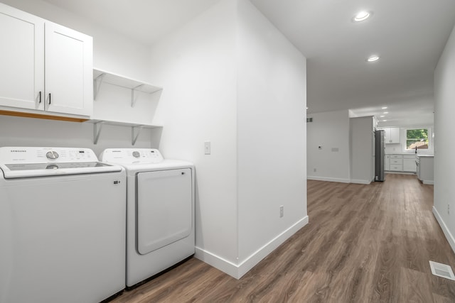 611 River Rd, Marshall, MI 49068 - clothes washing area featuring wood finished floors, baseboards, recessed lighting, and separate washer and dryer