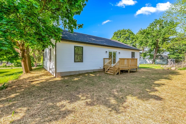 611 River Rd, Marshall, MI 49068 - rear view of house featuring a wooden deck and a lawn