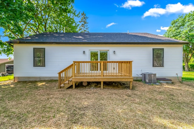 611 River Rd, Marshall, MI 49068 - back of house featuring central AC unit, a wooden deck, a lawn, and roof with shingles