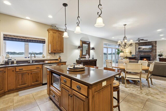 1259 Rose Dr, Niles, MI 49120 - kitchen featuring open floor plan, a tiled fireplace, dark countertops, a sink, and recessed lighting