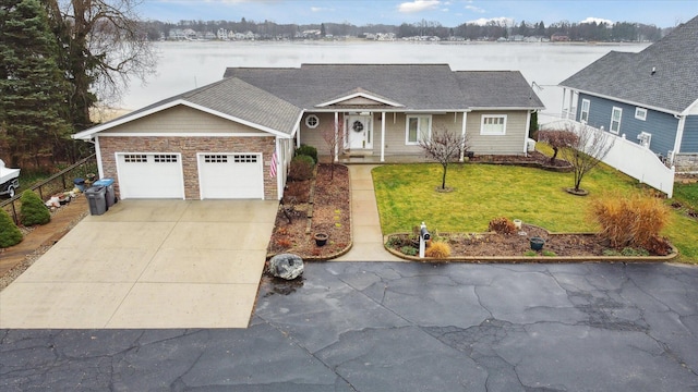 1259 Rose Dr, Niles, MI 49120 - view of front of house with driveway, an attached garage, and stone siding