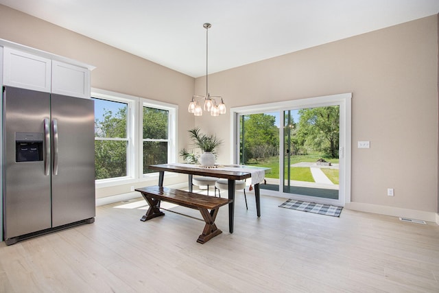 3401 Hicks Ave, Benton Harbor, MI 49022 - dining room featuring light wood-style flooring, a chandelier, and baseboards