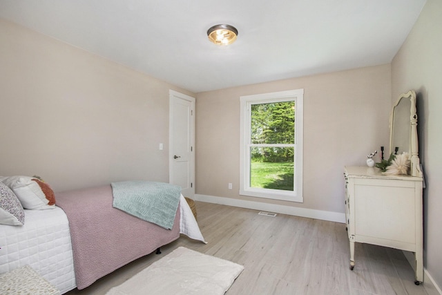 3401 Hicks Ave, Benton Harbor, MI 49022 - bedroom with light wood-style flooring and baseboards