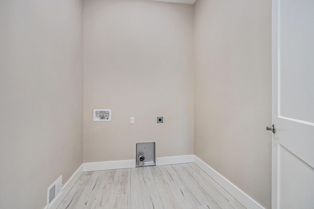 3401 Hicks Ave, Benton Harbor, MI 49022 - clothes washing area with hookup for an electric dryer, light wood-style floors, hookup for a washing machine, and baseboards