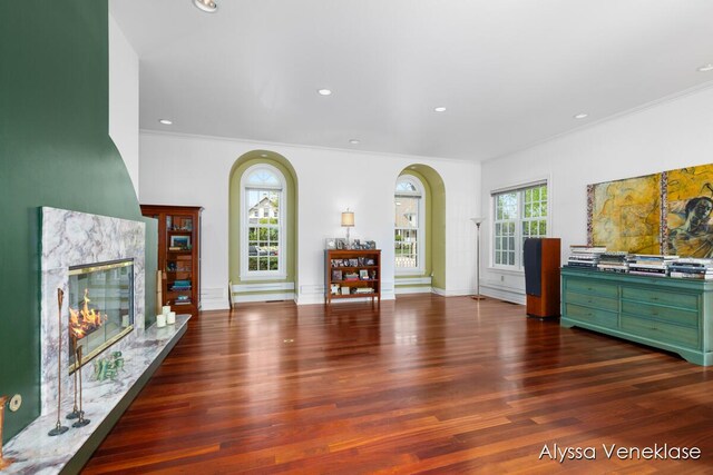 404 N Shore Dr, South Haven, MI 49090 - living area featuring ornamental molding, wood finished floors, arched walkways, a high end fireplace, and recessed lighting