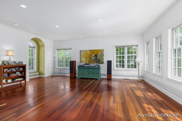 404 N Shore Dr, South Haven, MI 49090 - unfurnished living room with wood finished floors, baseboards, arched walkways, recessed lighting, and crown molding