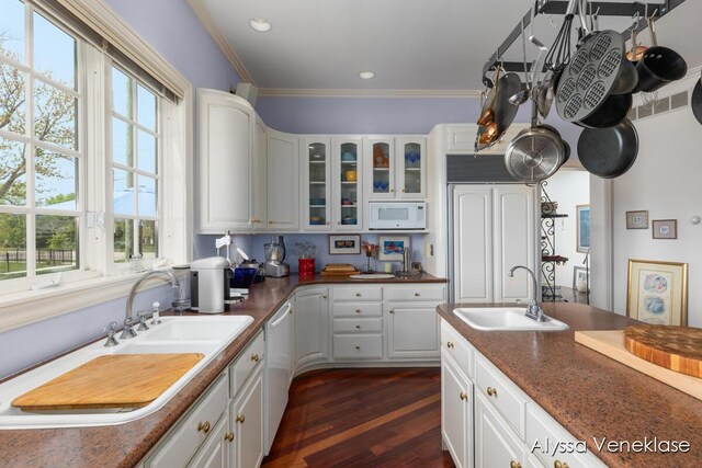 404 N Shore Dr, South Haven, MI 49090 - kitchen with white microwave, a sink, glass insert cabinets, white cabinetry, and ornamental molding
