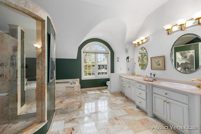 404 N Shore Dr, South Haven, MI 49090 - full bathroom featuring vaulted ceiling, a garden tub, double vanity, toilet, and a shower stall