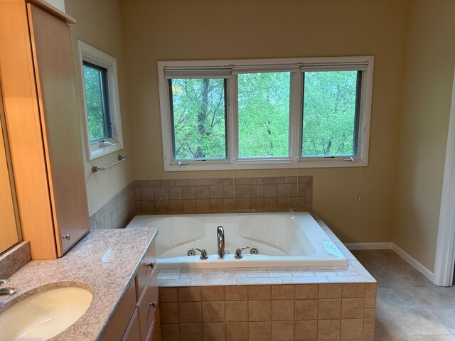 5316 Betheny Cir, Superior Twp, MI 48198 - bathroom featuring a tub with jets, vanity, tile patterned flooring, and baseboards