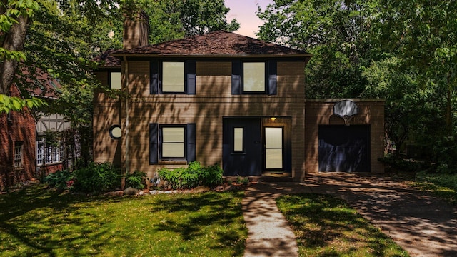 1711 Morton Ave, Ann Arbor, MI 48104 - view of front of home featuring driveway, a garage, a chimney, brick siding, and a lawn