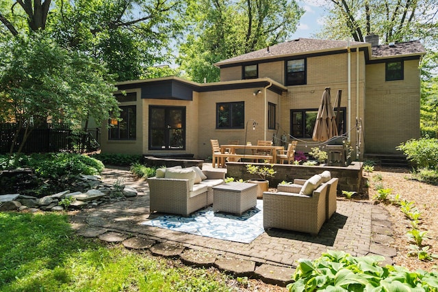 1711 Morton Ave, Ann Arbor, MI 48104 - back of property with french doors, brick siding, outdoor lounge area, and a patio