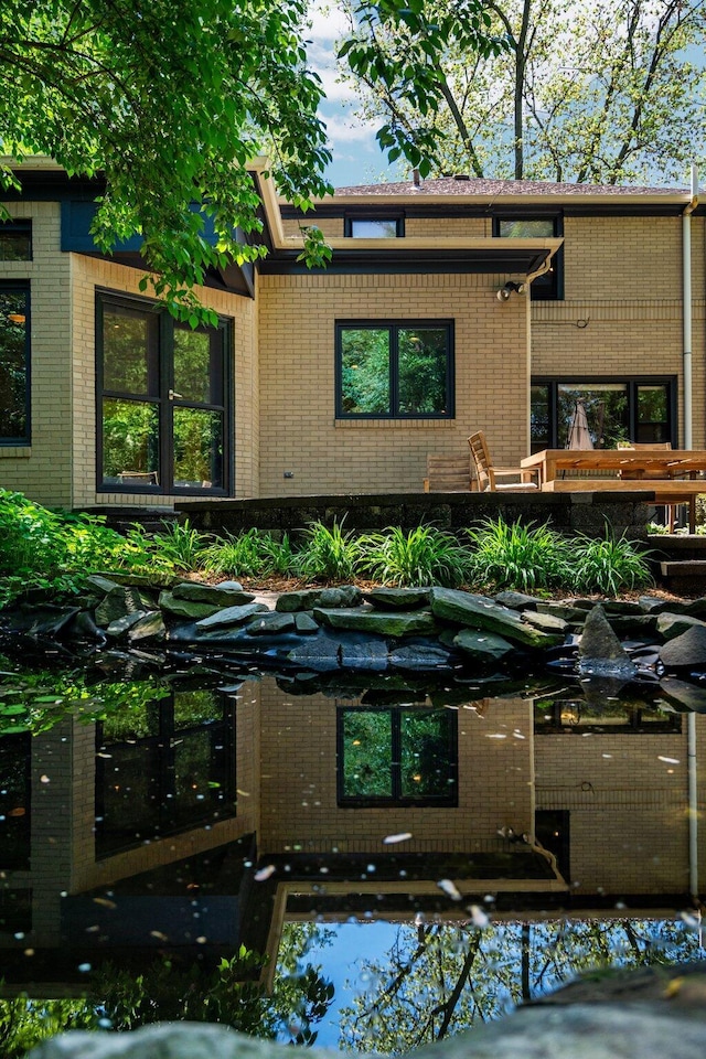1711 Morton Ave, Ann Arbor, MI 48104 - view of front of house featuring brick siding and a small pond