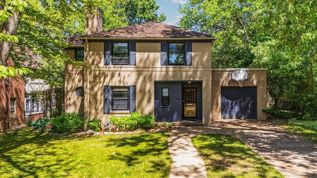 1711 Morton Ave, Ann Arbor, MI 48104 - colonial inspired home with driveway, a garage, a chimney, and brick siding