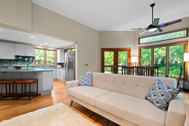 1711 Morton Ave, Ann Arbor, MI 48104 - living room with light wood finished floors, healthy amount of natural light, a ceiling fan, recessed lighting, and a towering ceiling
