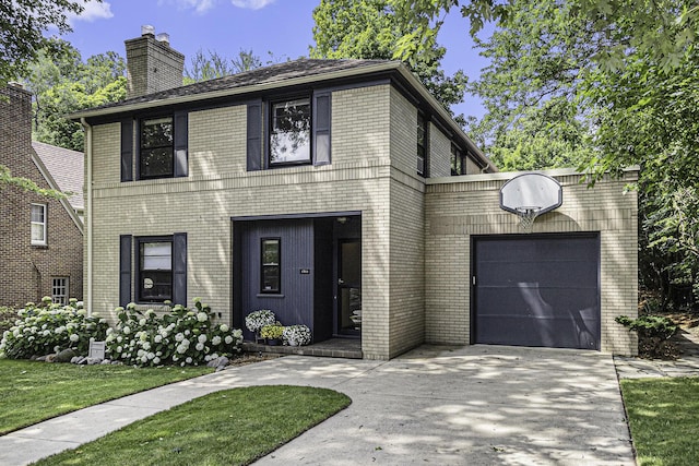 1711 Morton Ave, Ann Arbor, MI 48104 - view of front of home with driveway, brick siding, a chimney, and a garage