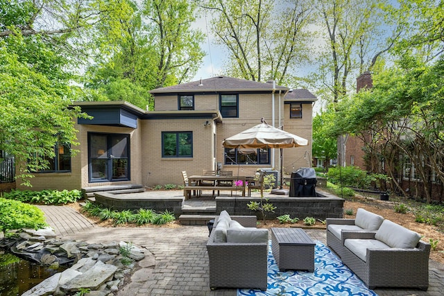 1711 Morton Ave, Ann Arbor, MI 48104 - back of house featuring an outdoor hangout area, a patio area, and brick siding