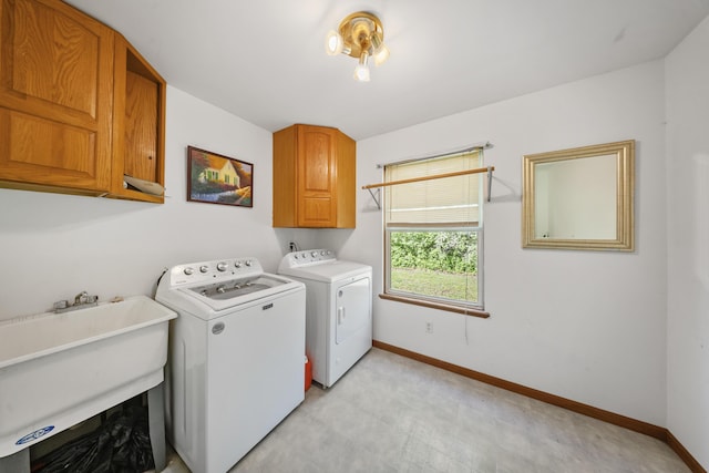 11486 Halsey Rd, Holly, MI 48442 - laundry area featuring washer and clothes dryer, cabinet space, baseboards, and light flooring