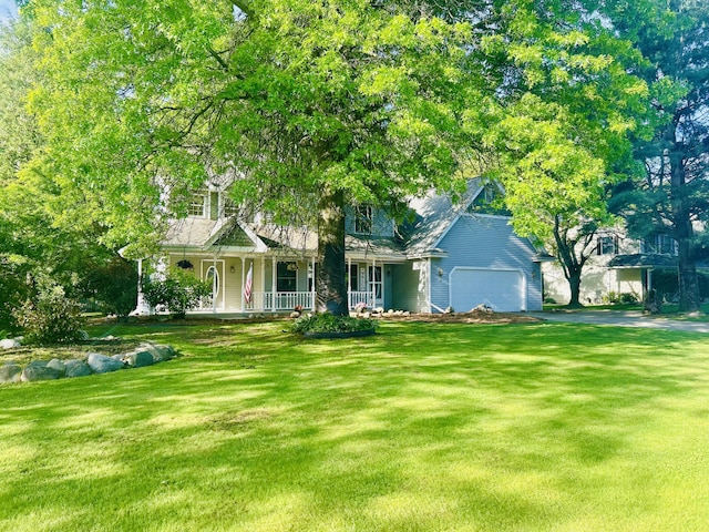5335 Heathrow Ave, Kalamazoo, MI 49009 - view of front of property featuring covered porch, a garage, a front lawn, and driveway