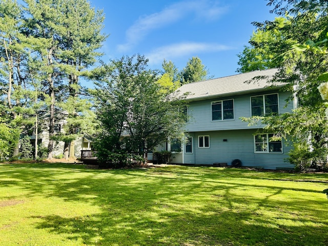 5335 Heathrow Ave, Kalamazoo, MI 49009 - rear view of house with a lawn and a wooden deck
