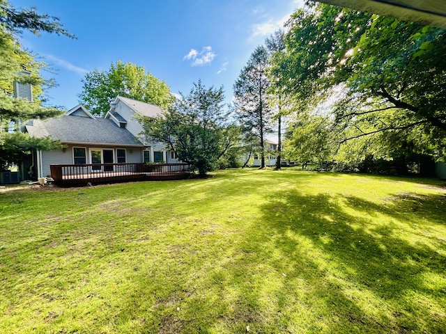 5335 Heathrow Ave, Kalamazoo, MI 49009 - view of green lawn with a wooden deck