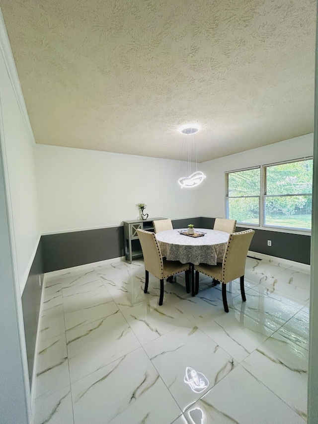 5335 Heathrow Ave, Kalamazoo, MI 49009 - dining space with marble finish flooring, baseboards, and a textured ceiling
