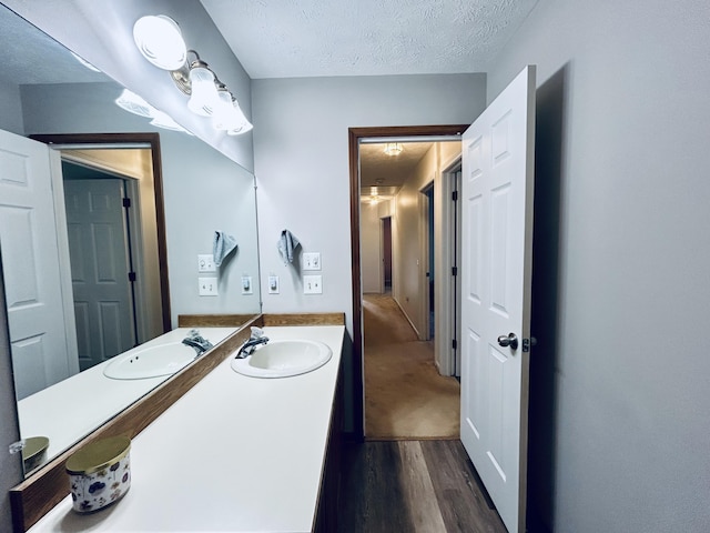 5335 Heathrow Ave, Kalamazoo, MI 49009 - bathroom with wood finished floors, a textured ceiling, and vanity