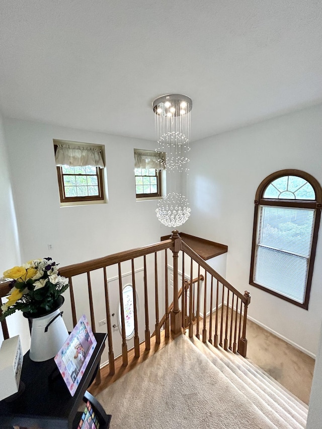 5335 Heathrow Ave, Kalamazoo, MI 49009 - stairway featuring a chandelier, carpet, and baseboards
