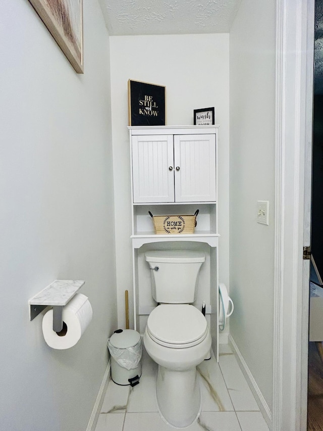 5335 Heathrow Ave, Kalamazoo, MI 49009 - bathroom featuring baseboards, toilet, and marble finish flooring